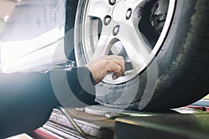 Car wheels maintenance in mechanical workshop photo