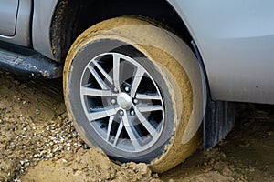 Car wheels stuck in mud.