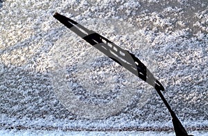 Car whiper blade and snow on glass with blur effect