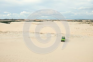 A car at White sand dunes in Muine, Vietnam.