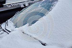 Car windscreen covered with snow