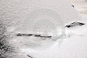 Car with windscreen wipers covered with snow outdoors on winter day