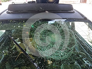 Car windshield broken by hail photo