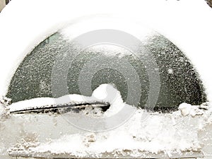 Car windshield covered with snow
