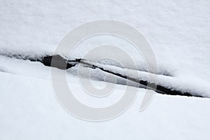 car windshield covered with snow. car detail in winter. Layout for decor and design at transportation.