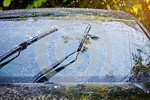 Car windshield with rain drops and frameless wiper blade