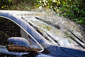 Car windshield with rain drops and frameless wiper blade