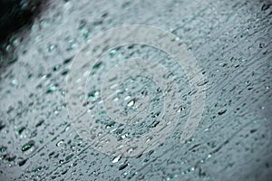 Car windshield after rain in drops and trickles of water depth of field