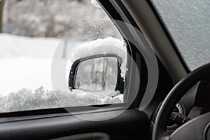 car windshield under a layer of snow