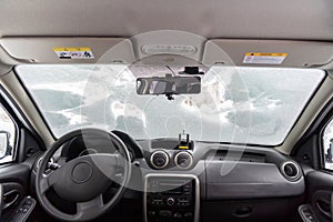 car windshield under a layer of snow