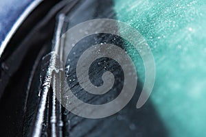 Car Windshield and Wiper Covered by Frost and Ice