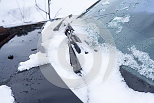 Car windshield wipers frozen in the snow