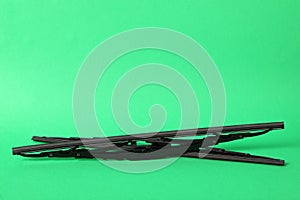 Car windshield wipers on green background. Space for text