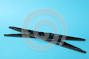 Car windshield wipers on light blue background. Space for text