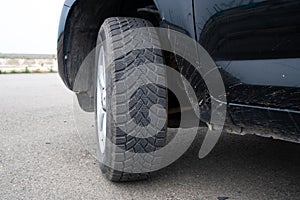 Car winter tire detail closeup, used car tires texture