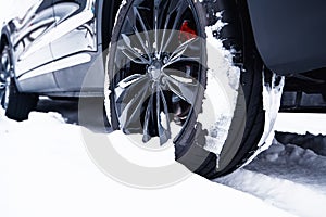 Car with winter tires on light-alloy wheels on the snow