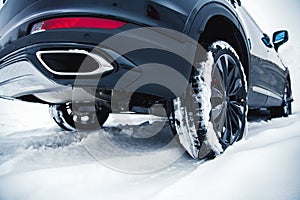 Car with winter tires on light-alloy wheels on the snow