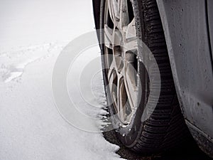 Car with winter tires and snow