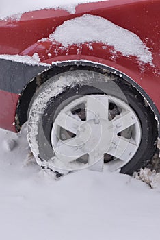 Car with winter tires on the snow covered road