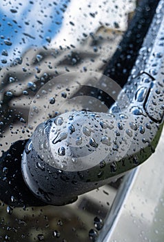 Car wiper, raindrops and reflection of a building in the glass