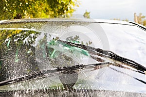 Car wipers wash windshield