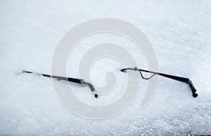 Car wipers and windscreen covered with snow