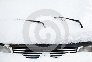 Car wipers and windscreen covered with snow