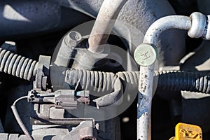 Car wiring, hoses and air conditioning duct. Dusty details of a flat-four boxer car engine compartment under the open hood