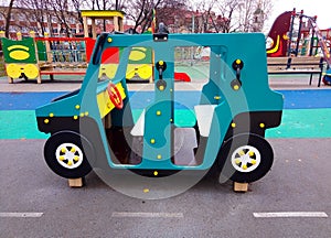 The car is wooden on the playground with a rubberized coating. Children's sports hobbies