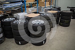 In car workshop there are many stacked car tires