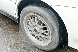 Car with worn bald tire unsafe and poses accident risk
