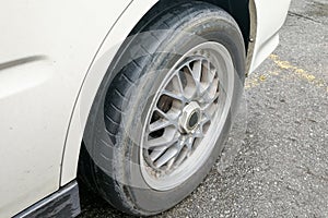 Car with worn bald tire unsafe and poses accident risk