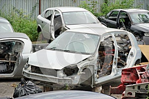 Car wracks on a scrapyard close up in a provincial town in Eastern Europe