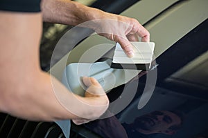 Car wrapper straightening foil with a squeegee photo