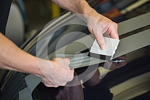 Car wrapper straightening foil with a squeegee photo