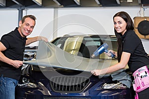 Car wrappers wrapping vehicle with vinyl film or foil