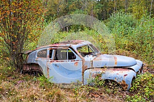 Car wreck in the forest at autumn