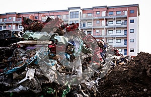 Car wreck yard with residential building in close proximity