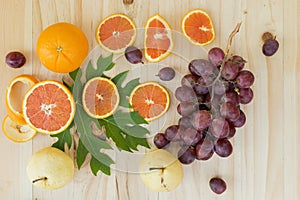 Cara orange and grape friut on the wooden table ,above view photo