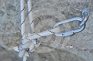 Carabine and hook with rope in stone photo