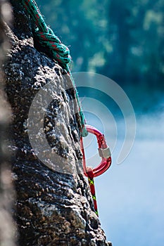 Carabiner between two ropes on a rock