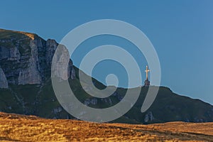 Caraiman Mountain Cross sunset, in Bucegi Mountains, Romania