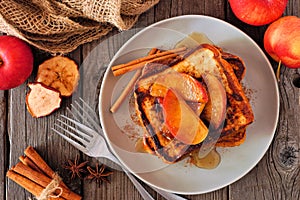 Caramel apple cinnamon french toast. Overhead view table scene on dark wood.