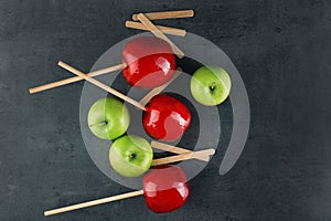 Caramel apples and wooden sticks, top view