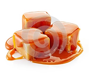 Caramel candies and caramel sauce photo