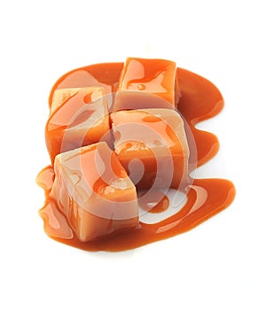 Caramel candies and caramel topping isolated on a white backgrou