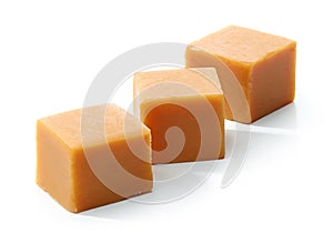 Caramel candies on white background