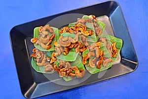 Caramel cashew nuts on banana leaves, Thai southern thailand traditional snack