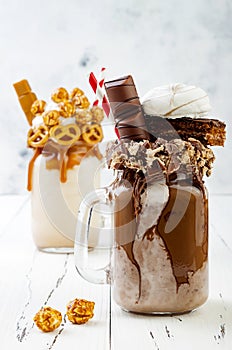 Caramel and chocolate crazy freakshake, milkshakes with brezel waffles, popcorn, marshmallow, ice cream and whipped cream.