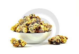 Caramel chocolate popcorn in white bowl